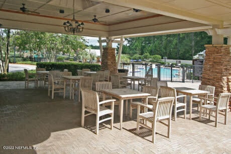 view of patio / terrace with a gazebo, ceiling fan, and a community pool