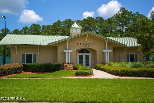 view of front of home featuring french doors and a front yard