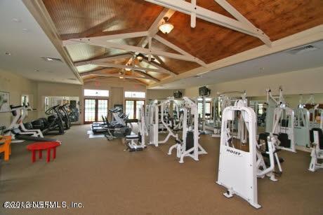 exercise room with lofted ceiling and wood ceiling