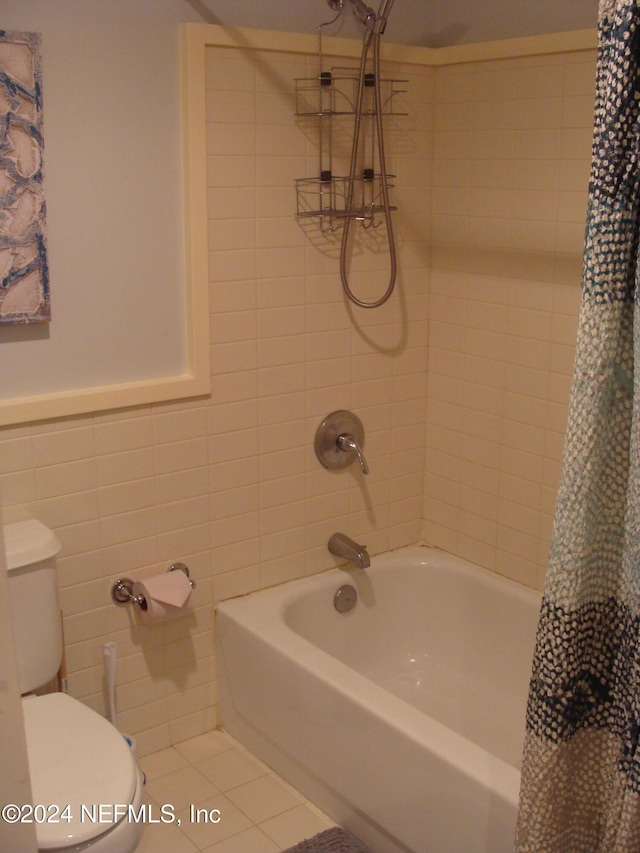 bathroom featuring tile patterned floors, shower / tub combo with curtain, and toilet