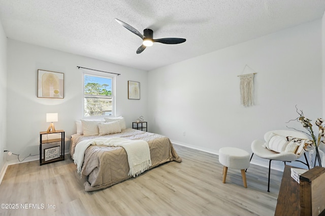 11657 Tanager Dr, Jacksonville, FL 32225 - bedroom featuring a ceiling fan, wood finished floors, baseboards, and a textured ceiling