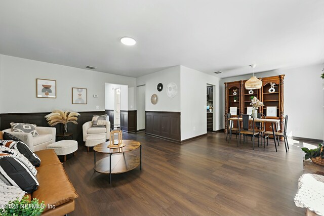 11657 Tanager Dr, Jacksonville, FL 32225 - living area featuring a wainscoted wall, dark wood-type flooring, a dry bar, and visible vents