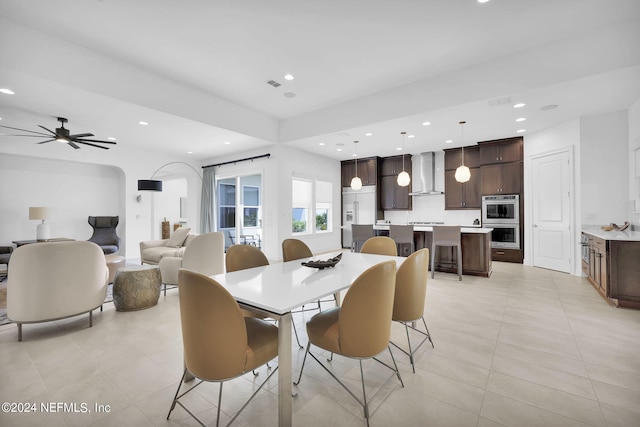 dining space featuring ceiling fan and light tile patterned flooring