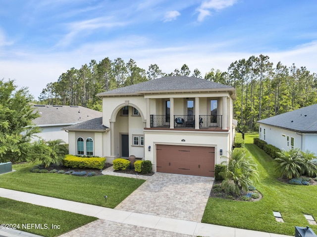 view of front of house with a balcony, a garage, and a front lawn