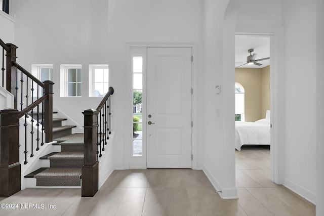 tiled entrance foyer with ceiling fan