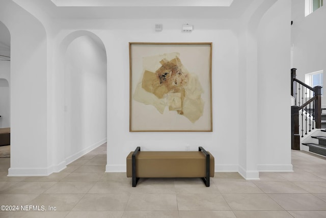 corridor with plenty of natural light and light tile patterned floors