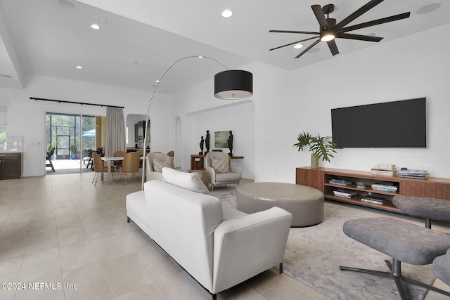 tiled living room with ceiling fan