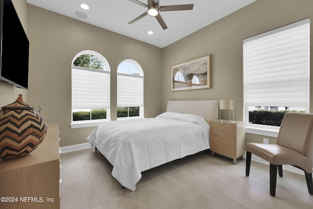 bedroom with ceiling fan and light tile patterned floors