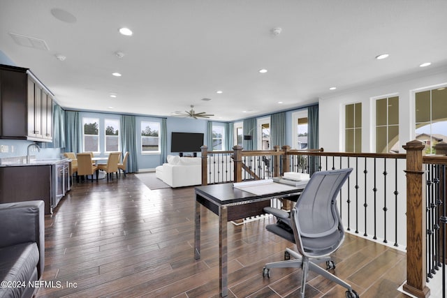 office area with ceiling fan, dark hardwood / wood-style flooring, and sink