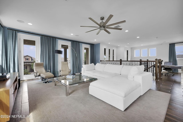 living room with ceiling fan and dark wood-type flooring