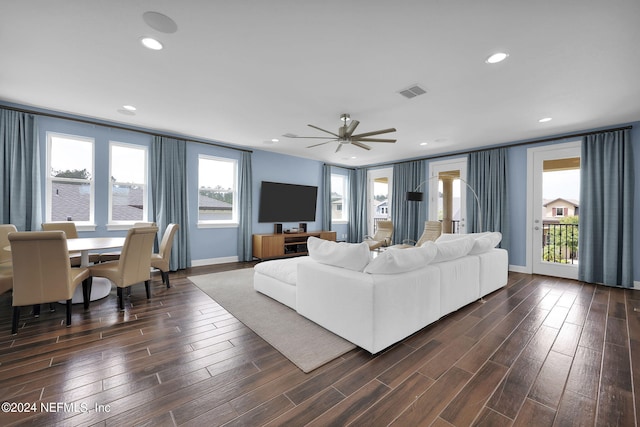 living room featuring ceiling fan and dark hardwood / wood-style flooring