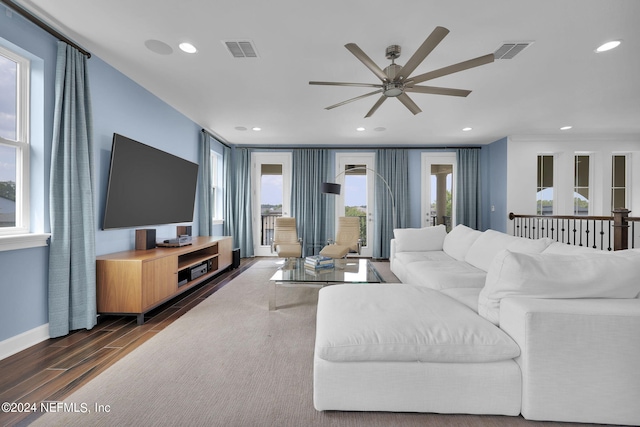 living room with dark hardwood / wood-style floors, a healthy amount of sunlight, and ceiling fan