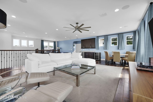 living room featuring hardwood / wood-style flooring, plenty of natural light, and ceiling fan