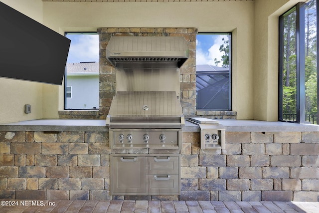 view of patio with area for grilling and a grill