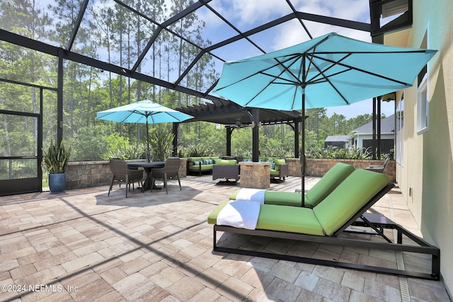 view of patio / terrace featuring an outdoor hangout area, glass enclosure, and ceiling fan