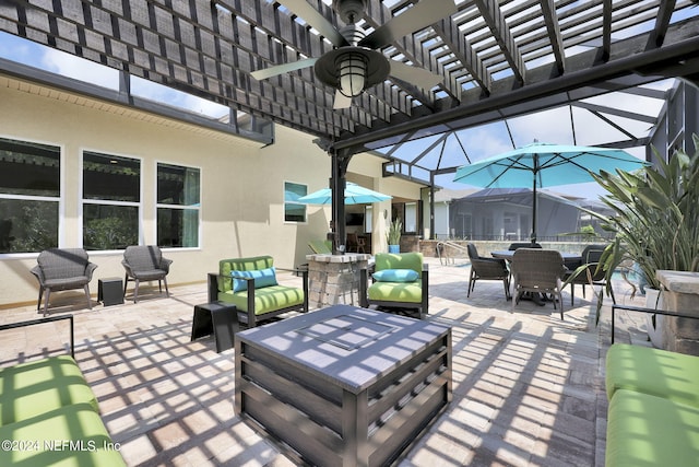 view of patio / terrace with an outdoor living space, ceiling fan, and a lanai