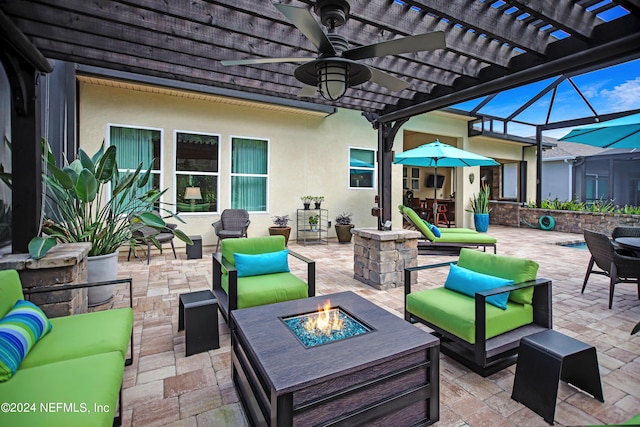 view of patio with an outdoor living space with a fire pit, a lanai, and ceiling fan