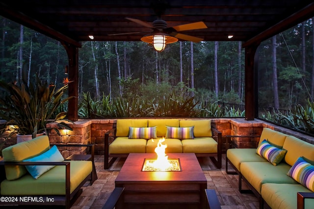 view of patio / terrace with a pergola, ceiling fan, and an outdoor living space with a fire pit