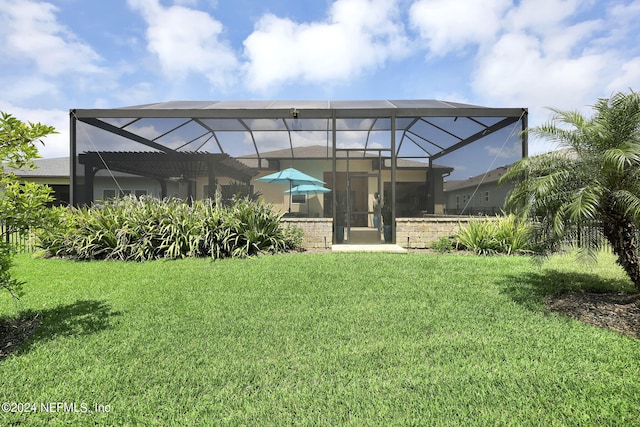 back of house with a yard and a lanai