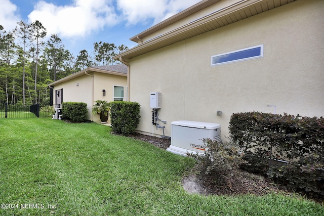 view of side of home with a lawn