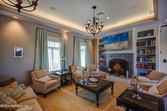 living room with built in shelves, an inviting chandelier, a tray ceiling, a fireplace, and wood ceiling