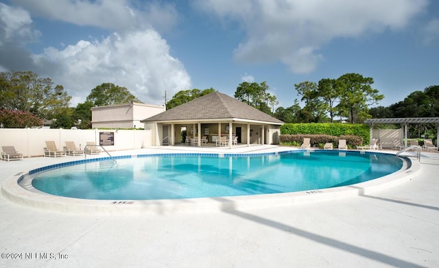 view of swimming pool featuring a patio area