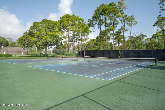 view of tennis court featuring basketball hoop