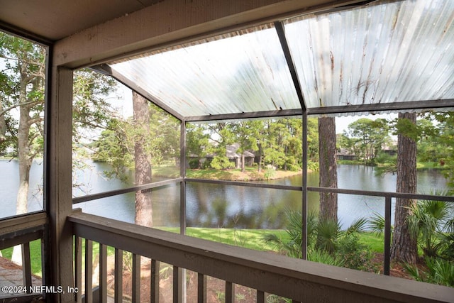 unfurnished sunroom featuring a water view and a wealth of natural light