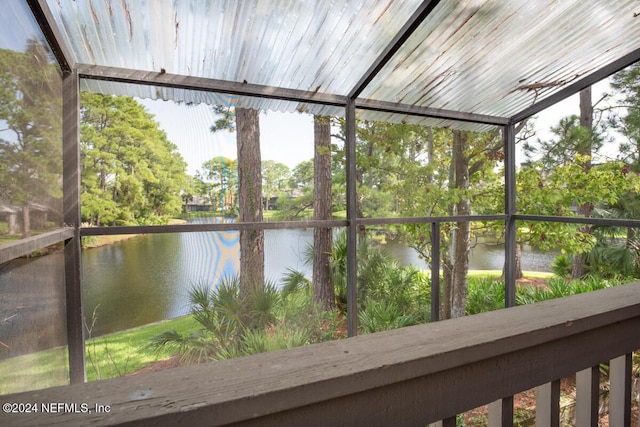 unfurnished sunroom with a water view