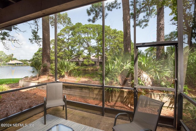 sunroom featuring a water view and plenty of natural light