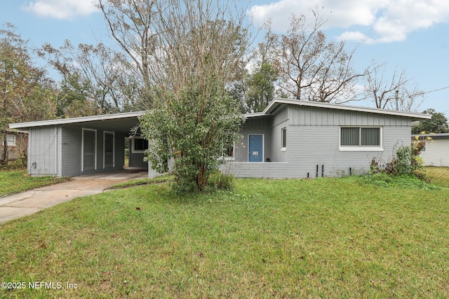 rear view of house with a yard and a carport