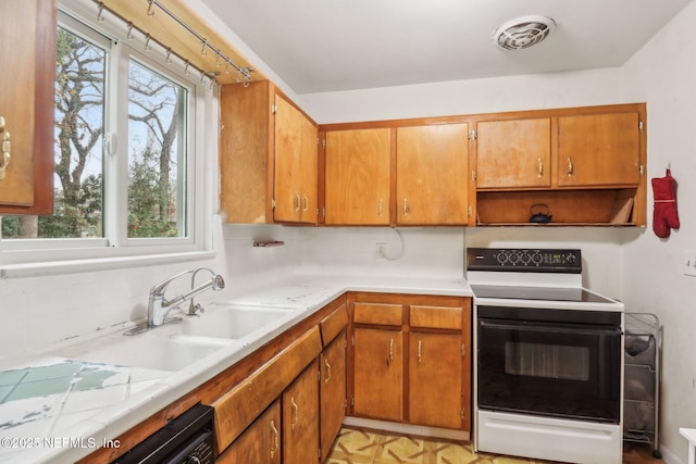 kitchen with backsplash, electric stove, and black dishwasher