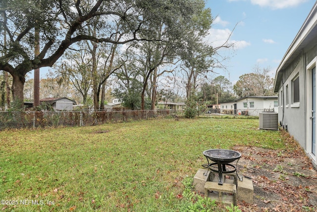 view of yard featuring a fire pit and cooling unit