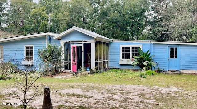 back of house featuring a sunroom