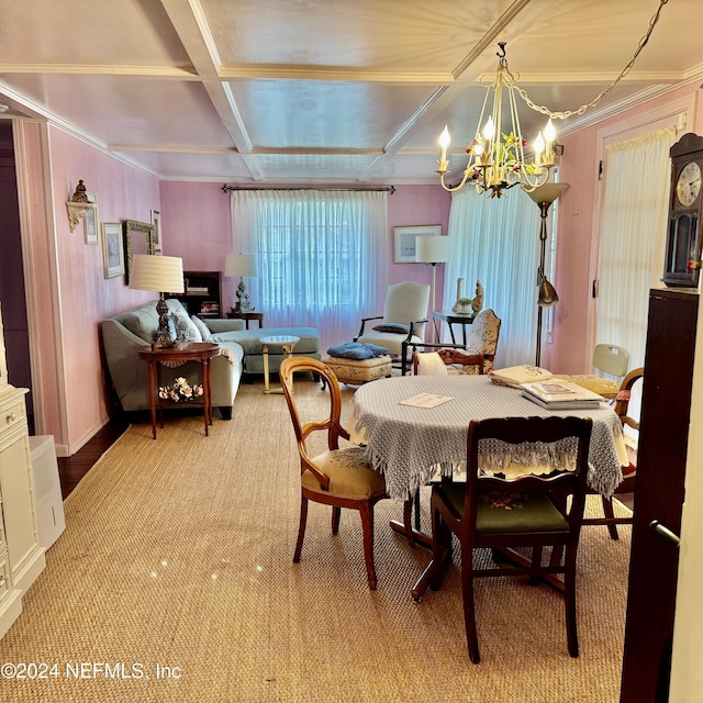 dining room featuring ornamental molding, a notable chandelier, and coffered ceiling