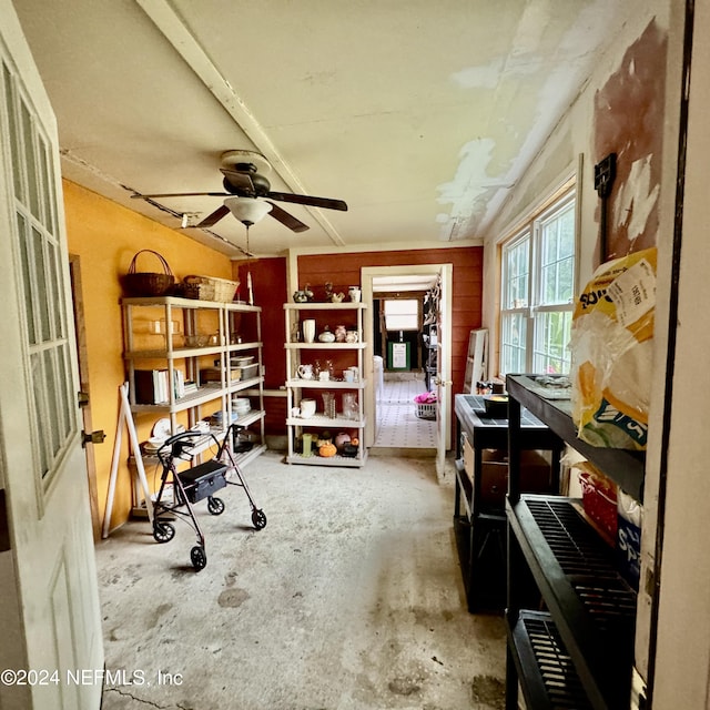 misc room featuring ceiling fan and concrete floors