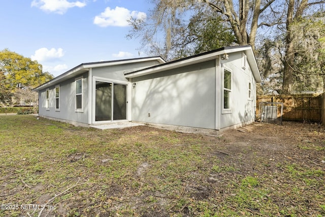 back of property featuring a lawn