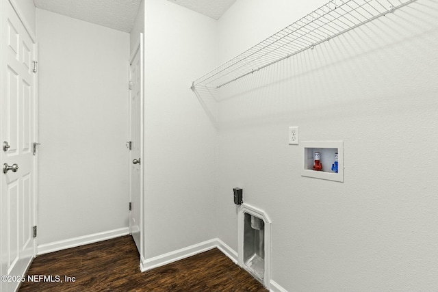 laundry room featuring dark hardwood / wood-style flooring, hookup for a washing machine, and a textured ceiling