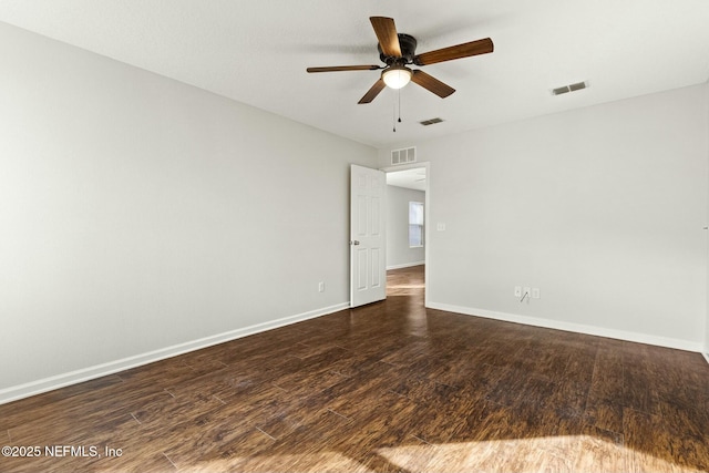 empty room with dark wood-type flooring and ceiling fan