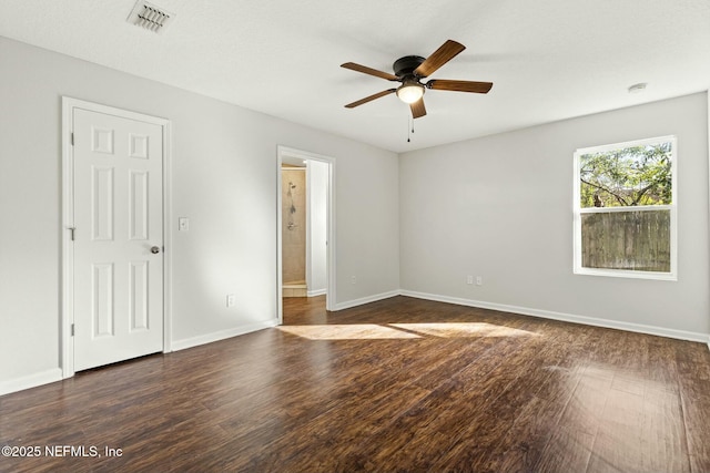 unfurnished room with dark hardwood / wood-style floors and ceiling fan