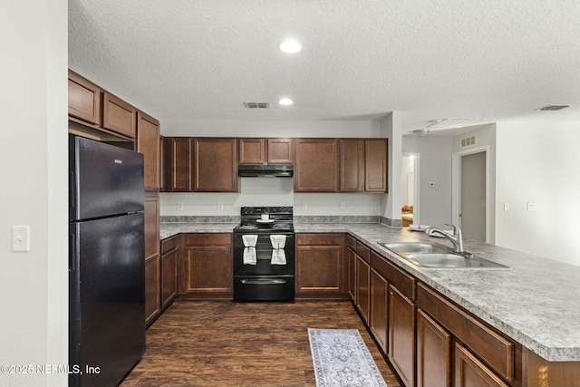 kitchen with dark hardwood / wood-style floors, black appliances, sink, kitchen peninsula, and a textured ceiling