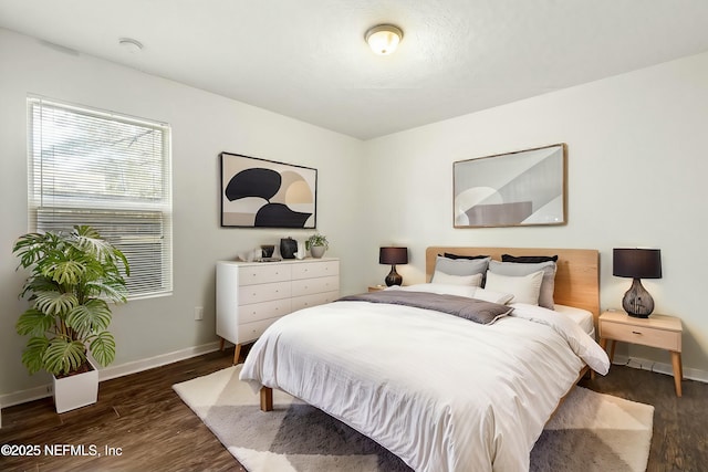 bedroom with dark hardwood / wood-style floors