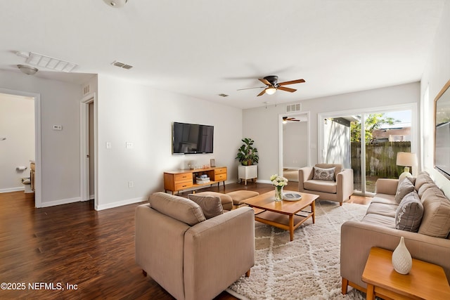 living room with ceiling fan and dark hardwood / wood-style floors