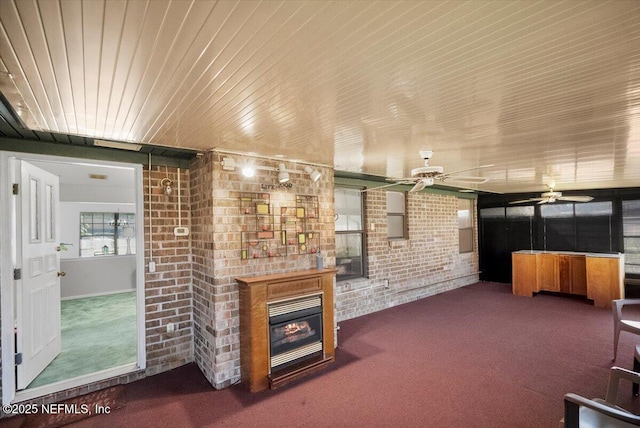 living room with carpet flooring and brick wall