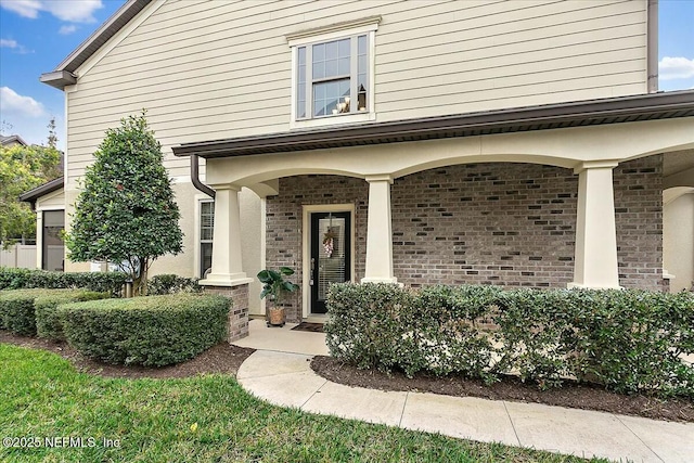 doorway to property featuring covered porch