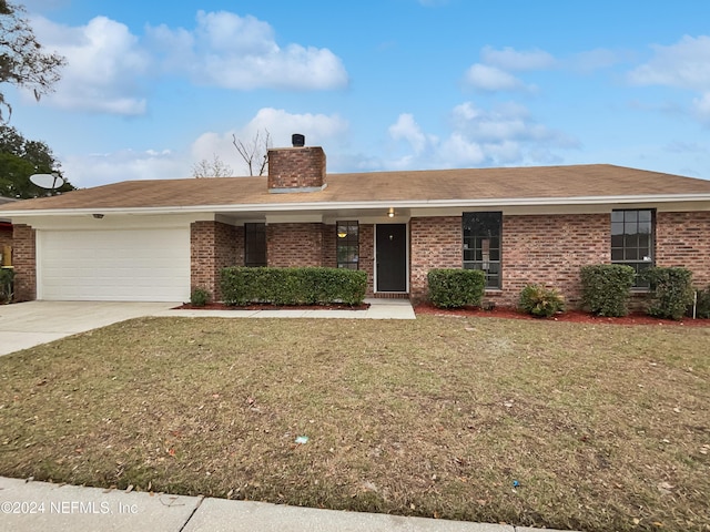 ranch-style house with a front yard and a garage