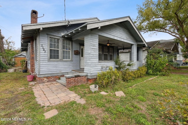 bungalow-style home with a front yard