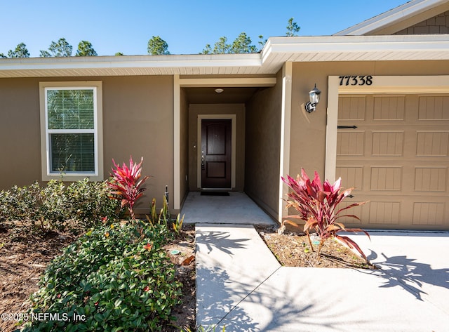 view of exterior entry featuring a garage