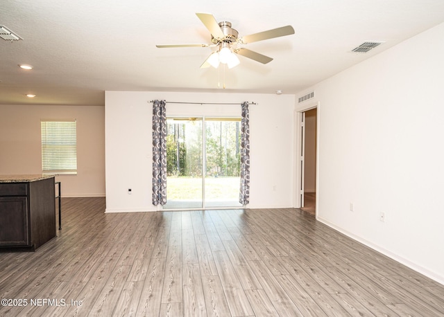 spare room featuring ceiling fan and light hardwood / wood-style flooring