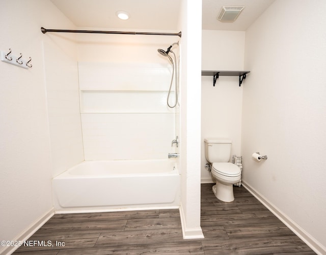 bathroom featuring hardwood / wood-style floors,  shower combination, and toilet